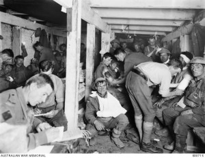 Wally Goodlet seated far right rear looking at camera with neck bandage. Ypres 1917 . AWM E00715